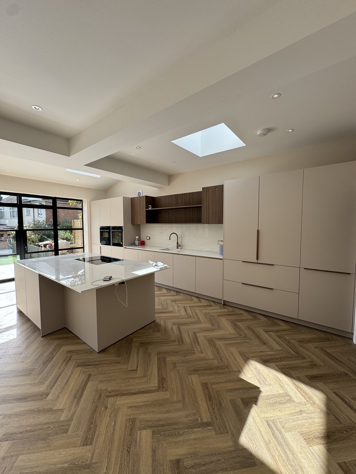 Bright open-plan kitchen extension with roof lights in a London home