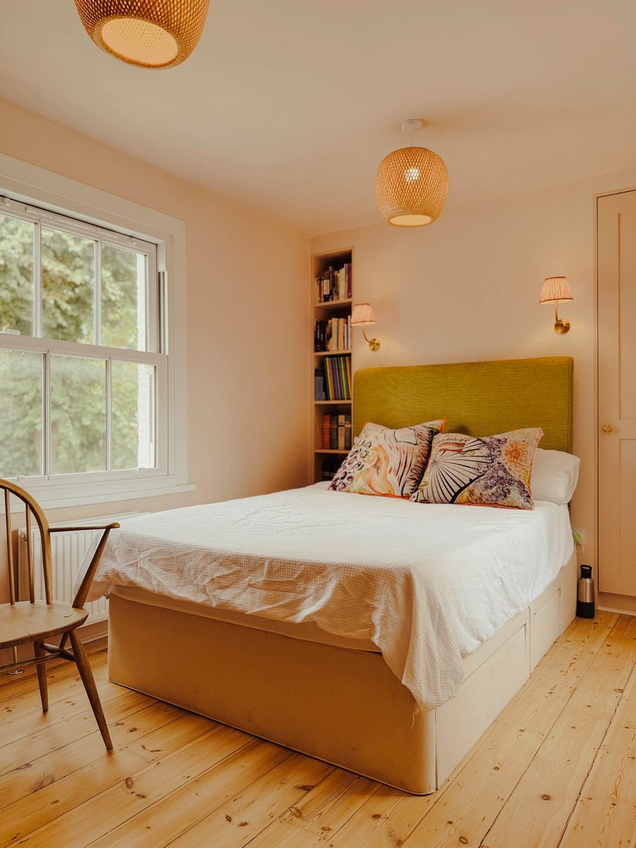Limehouse Cottage: bedroom with restored sash window and fitted shelving