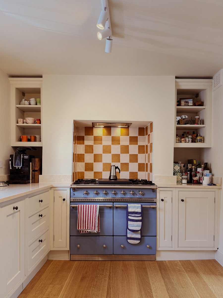 Limehouse Cottage: the new kitchen with open shelving either side of the range cooker