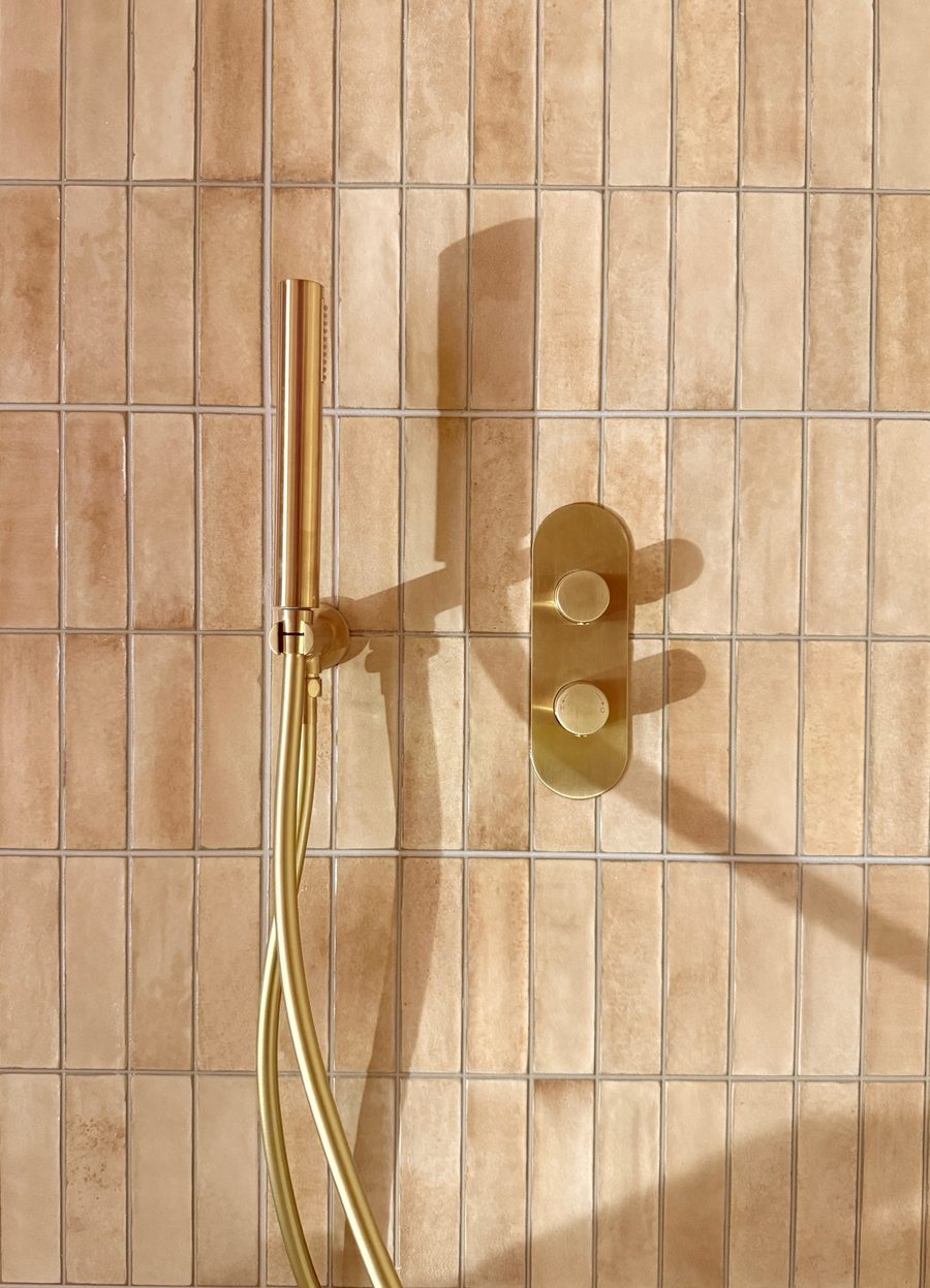 Limehouse Cottage: shower room with copper-coloured tiles and brass fittings