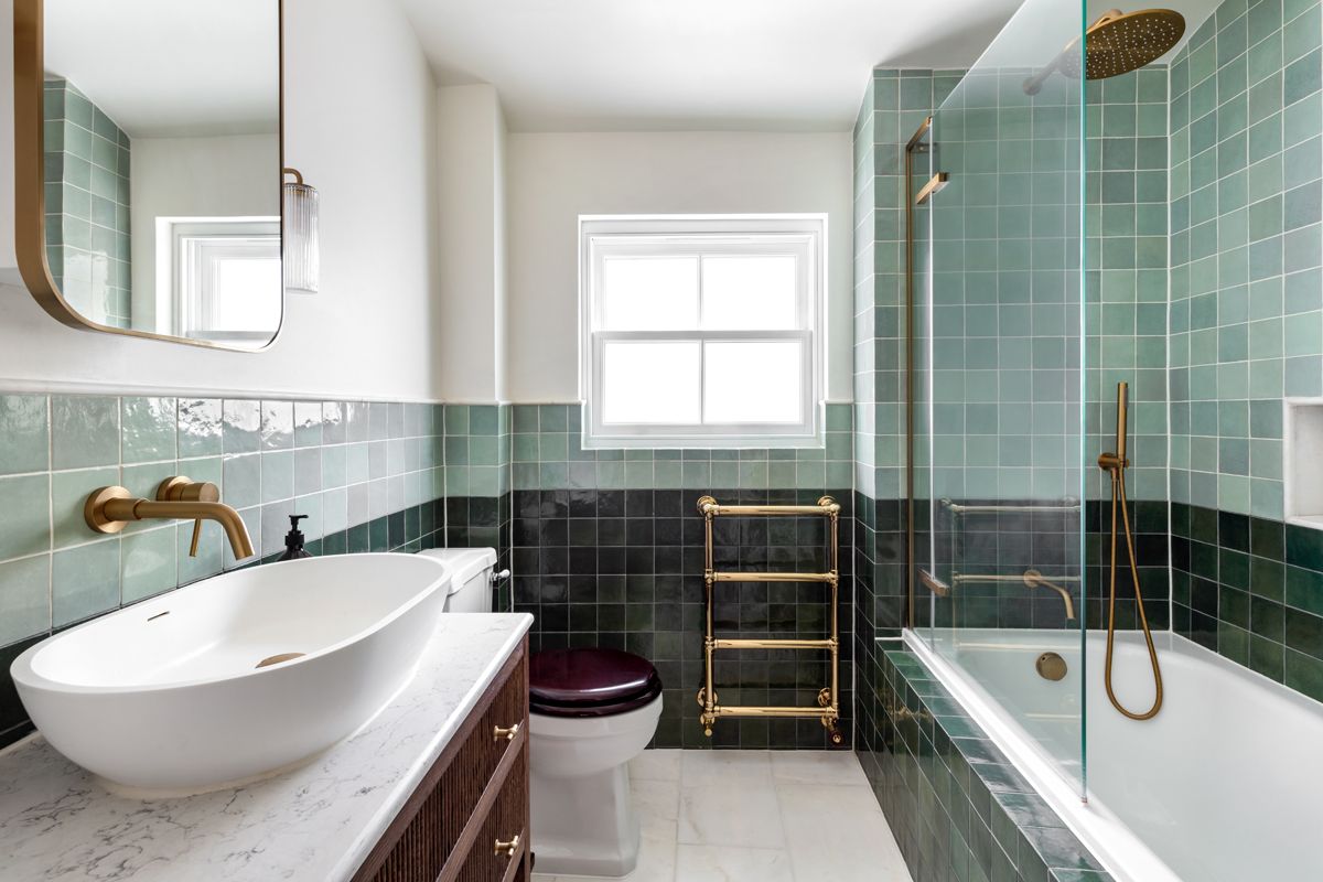 Lyal Road Bow East London — green tiled bathroom with brass towel rail and fixtures