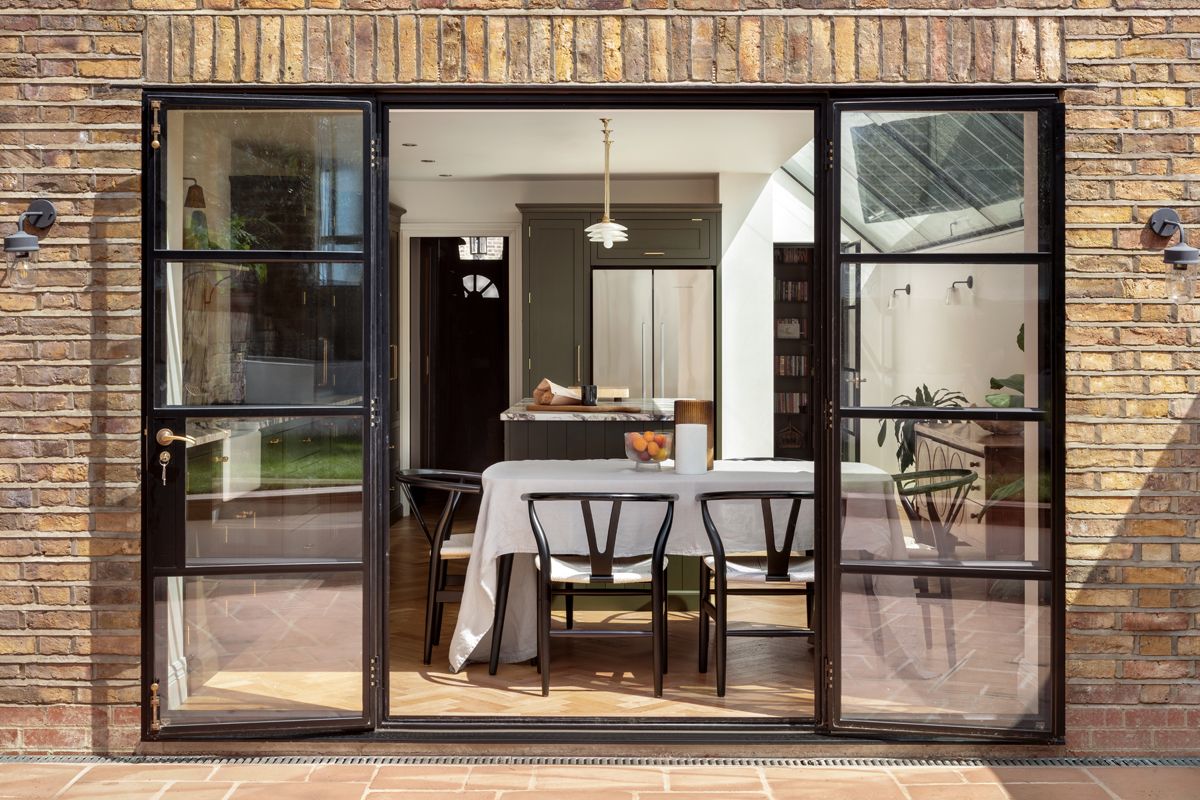 Lyal Road Bow East London — dining area under glazed roof with Crittall doors to garden