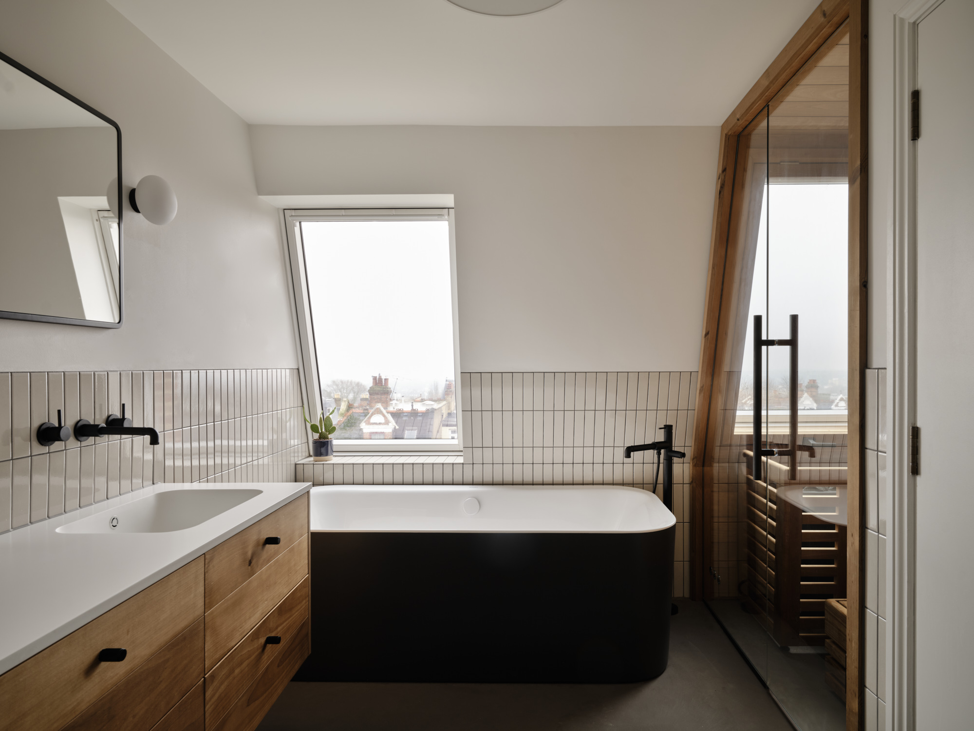 Whitehall Park Archway — loft bathroom with freestanding tub, oak vanity and premium tiling